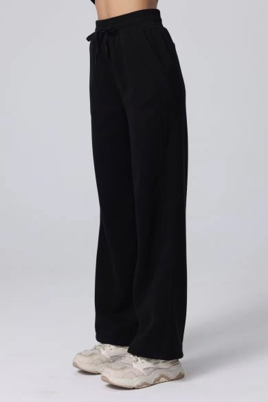 Black wide-leg pants worn by a person on a white background